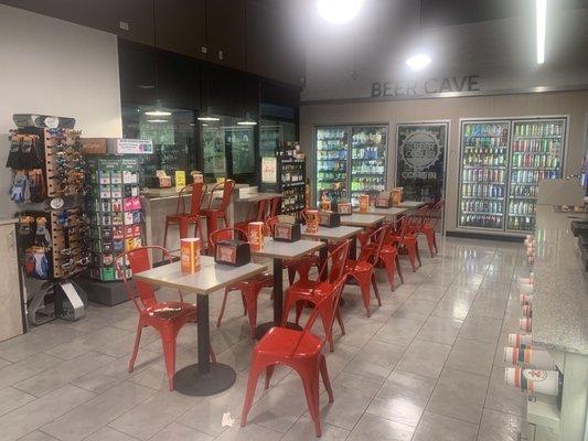 The seating area inside 7 Eleven. Nice store.