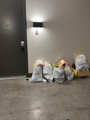 Trash left from Thursday to Sunday leaking and stinking up the hallway in 100 degree temps