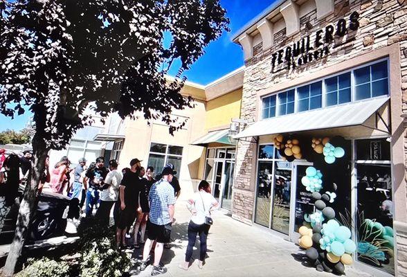 Line of people waiting patiently for their Grand Opening.