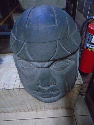 A giant Aztec style head by the front door.