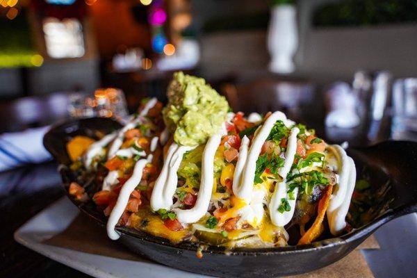 The Ainsworth Hoboken Nachos Supreme ! black beans, cheddar, jack cheese, jalapeño, guacamole, sour cream, pico de gallo