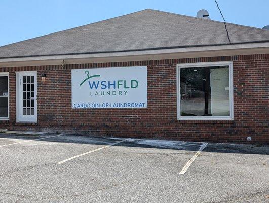 Side entrance of wshfld laundromat. Cash, Card, Coin or App