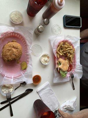 Spicy chicken sandwich with slaw. Cheeseburger with fries and slaw.