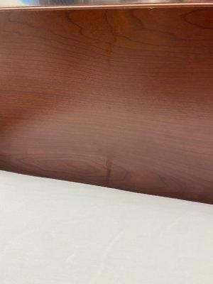 Partially wiped long light drip stain on the headboard