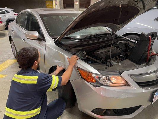 Felix backed my car out while the hood was open and the battery charger was attached to the engine. He smashed my car into his tow truck.