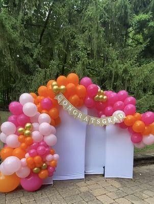 A grad party balloon arch backdrop for the ages!