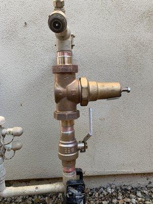 Water main shut off and a pressure regulator