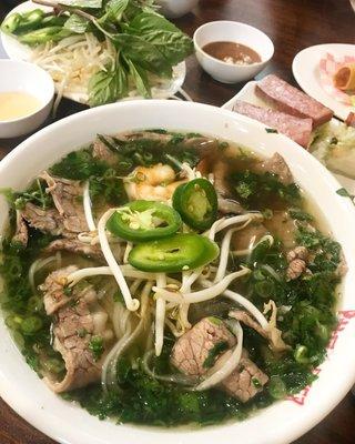 Well done brisket pho & nem nuong in the background