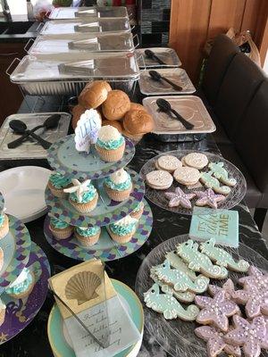 Beach themed surprise birthday party. Sea creature cookies and cupcakes.