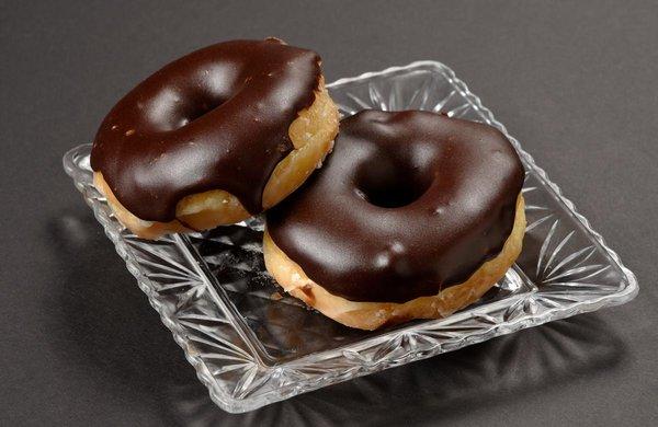 Chocolate covered glazed donuts.