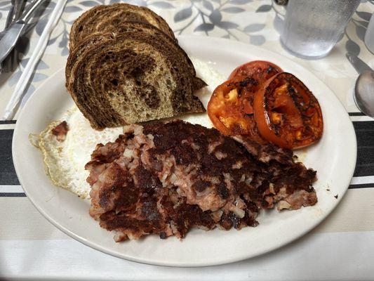 Corned beef hash, rye toast, eggs over medium, and grilled tomatoes