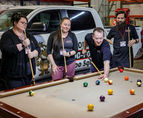 Office Support Staff team building company pool table. Pooper Scoopers here to you!