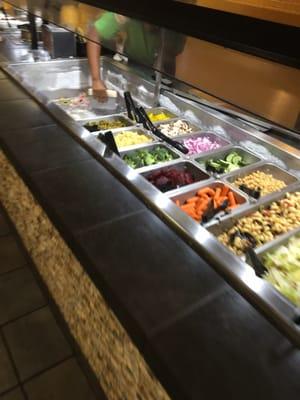 She is literally scrapping ice from the sides of the salad bar. Ice was flying all over the other exposed parts of the salad -