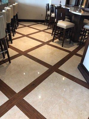 Travertine floor with wood inlay after polishing