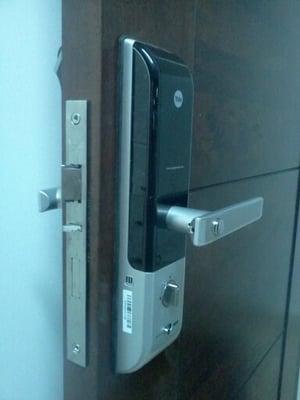 Yale biometric lock. Installed with minimal space left between door and jamb.