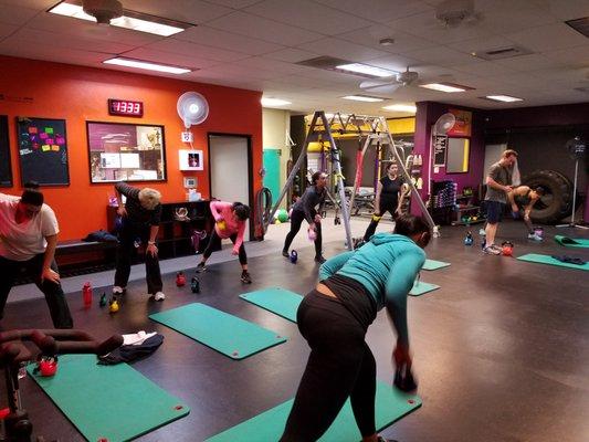 6am Kettlebell class performing a bent over row move.