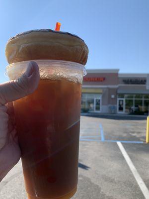 Iced coffee with a donut.