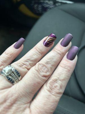 Matte nails with embellishment on ring finger