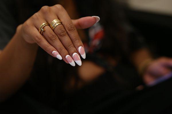 Classic French manicure on almond nails, an eternal style statement. #FrenchManicure #TimelessElegance