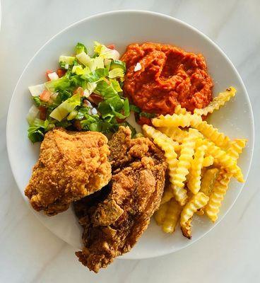 Fries, chicken, red humus and a salad on the side.