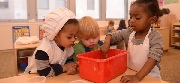 Toddlers whip up a batch of playdough