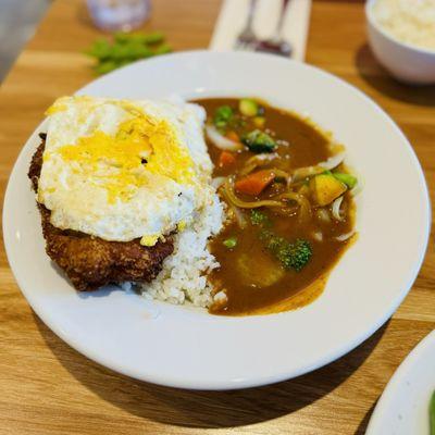 Tonkatsu curry topped with well-done egg and veggies