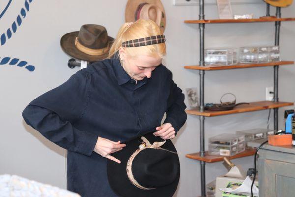 Local designer experts work on a one of a kind hat for celebrity country singer duo Tigirliy Gold