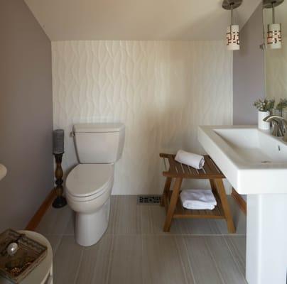 Powder Room with organic large format porcelain tile as focal point. Toto Sink and toilet. Vertically installed backsplash