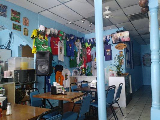 Seating area with Honduran soccer club swag against the wall.  (this is Lili's #2 in Richardson)