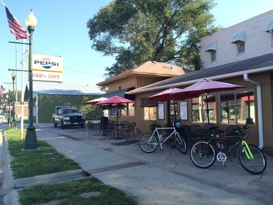 Storefront space features a bike rack and tables for outdoor dining.