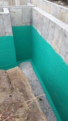 Foundation Waterproofing - Rub-R-Wall spray coating.