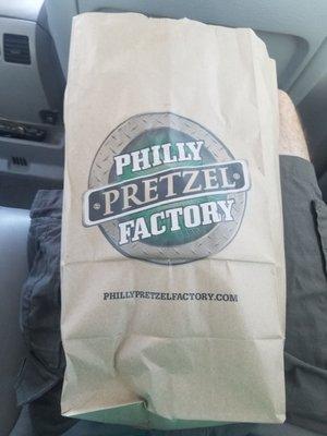 Seeing this paper bag filled with soft pretzels is honestly the best feeling.