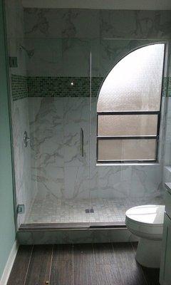 Frameless shower enclosure