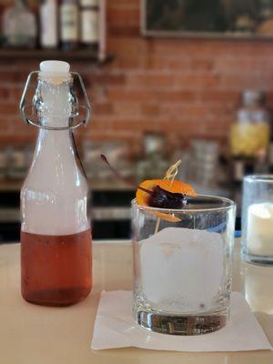 Smoked old fashioned, pictured as initally served in carafe