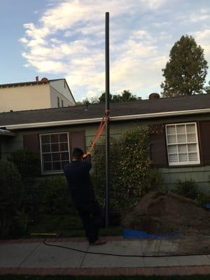 Replacing main sewer line using trench less pipe burst technology