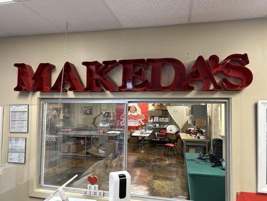 Makeda's song with a view of their facility that produces packaged butter cookies for grocery stores.