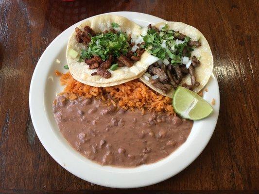 Beef and spicy pork tacos with rice and beans