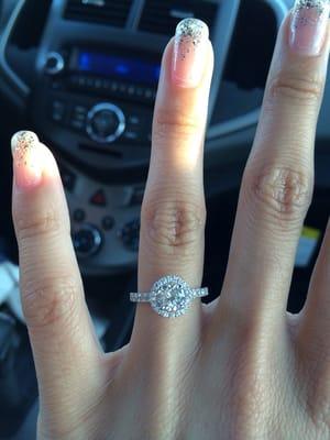 My fiancé's ring.  A 3/4 karat solitaire with a diamond halo just a tad below it. White gold band with diamonds.