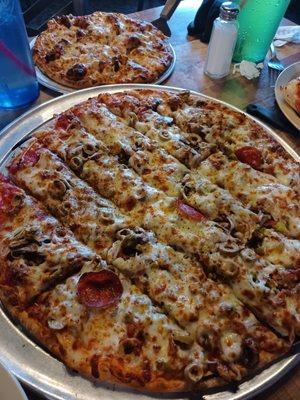 Around the World large pizza and Mini Spaghetti with meatball pizza in background