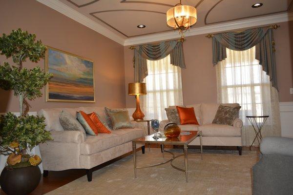 Fully designed living room featuring color, celing design, furniture, custom windows treatment, area rug and accessories