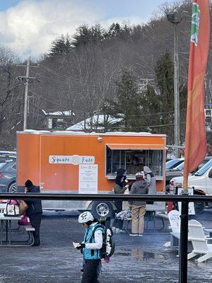 Waffle shack located in parking lot by bridge