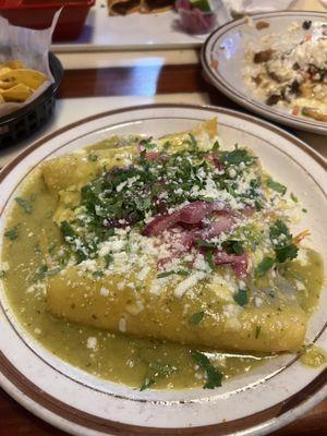 Chicken Enchiladas topped with green sauce. Not spicy at all.