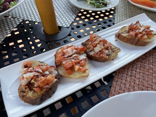 A very kind courtesy of the chef! bruscetta with tomatoes, cheese, garilc and bread