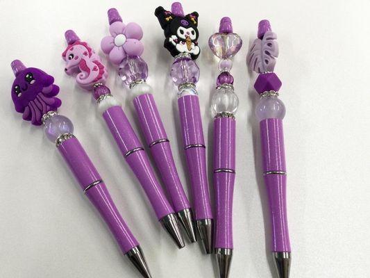 A selection of purple beaded pens