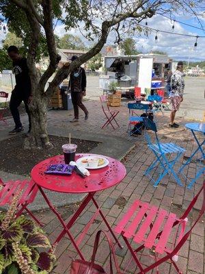 Seating area, plate of pupusas, food truck