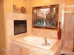 Travertine wrapped spa tub, with fireplace