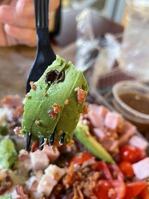 Cobb Salad with balsamic vinaigrette and Greek dressing. Avocado cut with stem still attached.