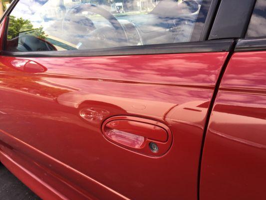 Door that had dent that was "smoothed" out before. Now it's actually smooth & flat w/matching polish. They even wax washed my car :)