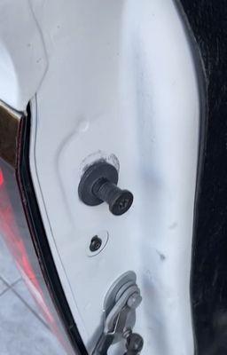 Loose tailgate bolt caused paint damage.