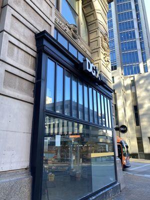 Store entrance, understated on a fancy historic building